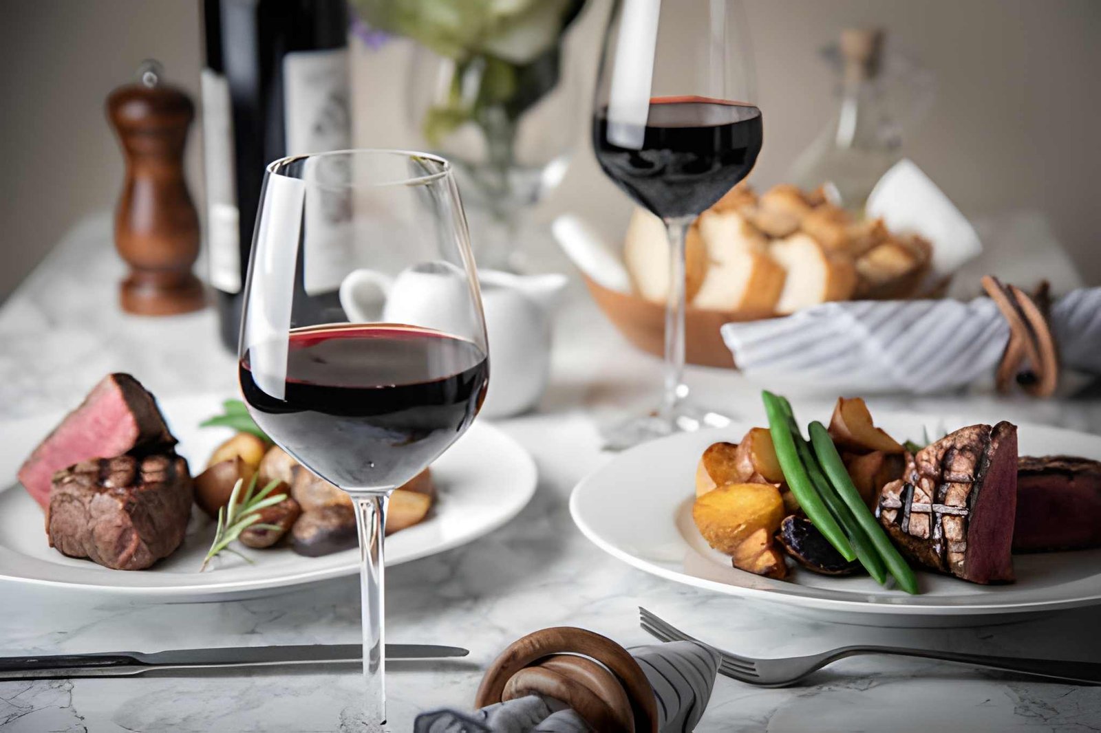 Fine dining table setting with premium steak and wine